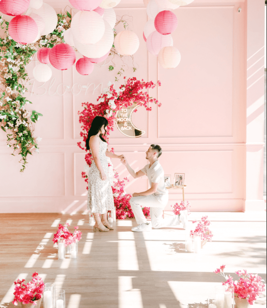 all pink proposal pink flower arch asymmetrical flower arch moon proposal to the moon and back sign luxury proposal the yes girls down on one knee