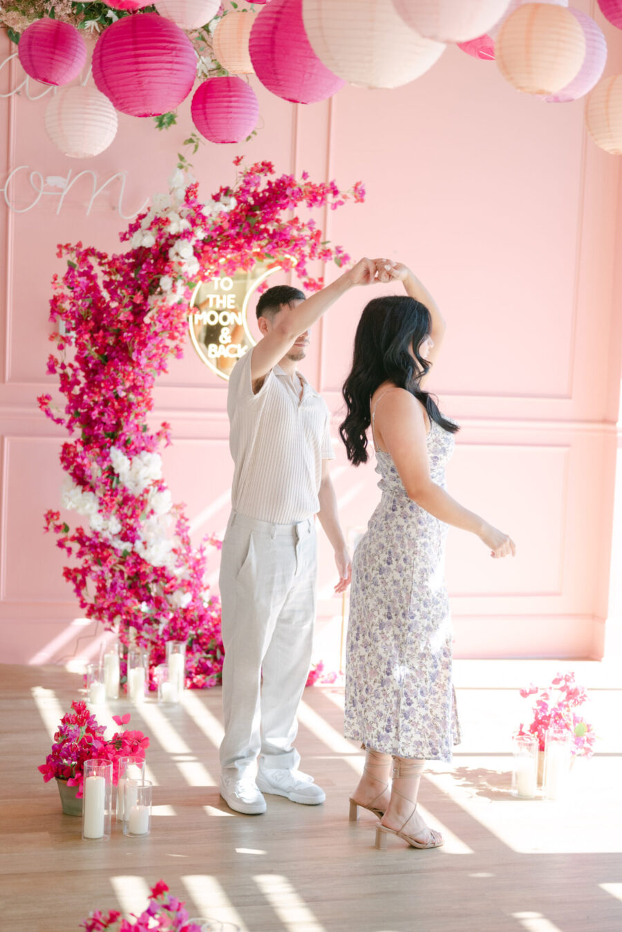 all pink proposal pink flower arch asymmetrical flower arch moon proposal to the moon and back sign luxury proposal the yes girls couple dancing