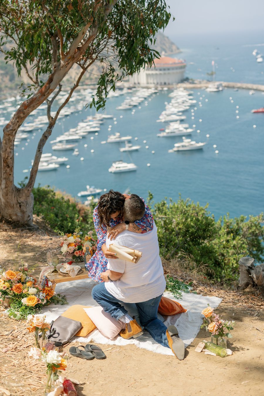 Private Picnic Proposal on Catalina Island. Charcuterie board, champagne, and picnic table set up for the proposal with an ocean view