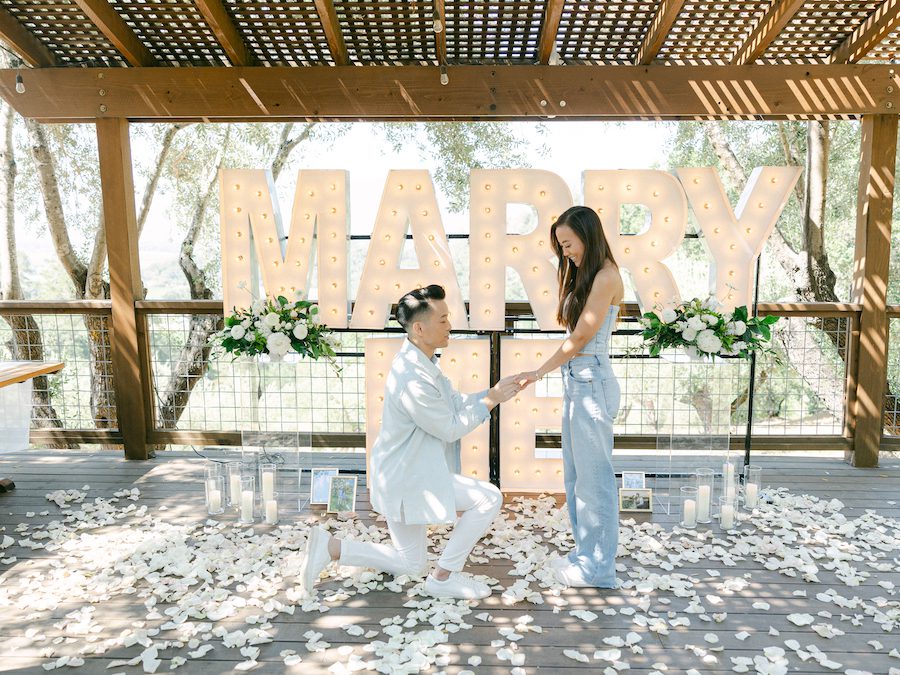 Napa valley proposal iwth white flowers and marry me sign by the yes girls