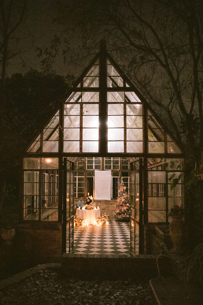 Romantic Austin proposal inside the checkered floor glasshouse with holiday decor and candlelight