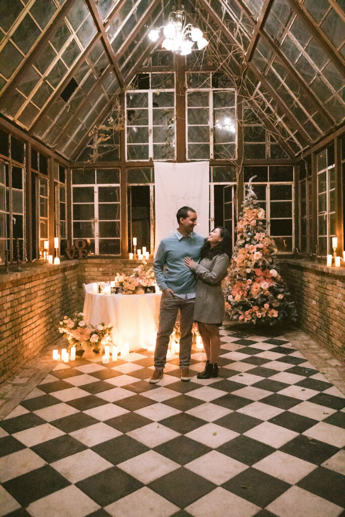 Intimate holiday proposal in Austin glasshouse with custom decor and romantic florals