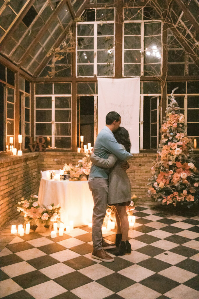 Intimate holiday proposal in Austin glasshouse with custom decor and romantic florals