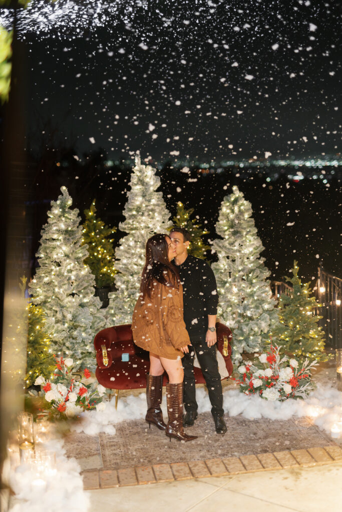 Festive holiday proposal scene with Christmas trees and romantic ambiance
