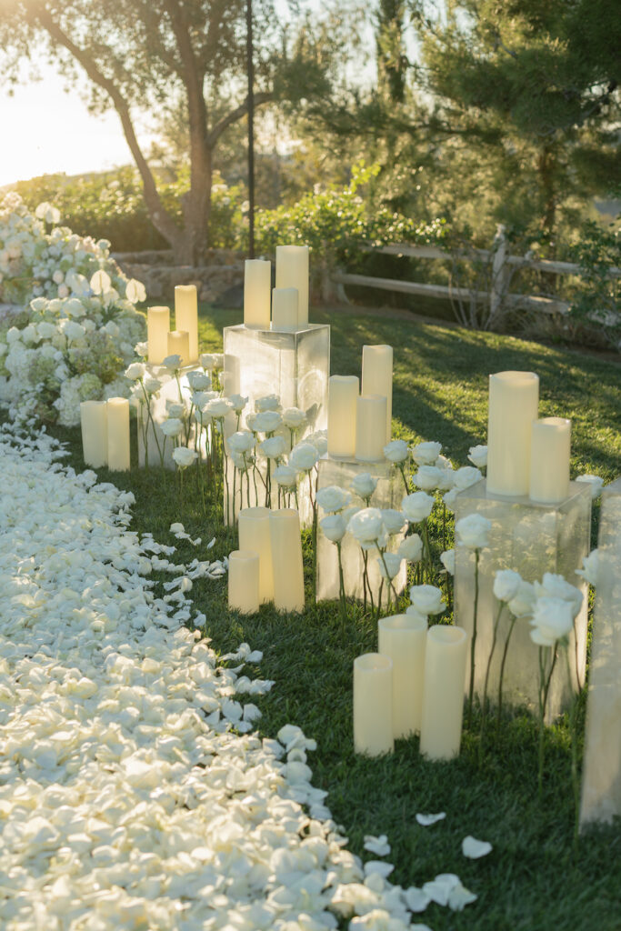 Luxury Malibu proposal featuring a white rose aisle and elevated ceremony platform planned by The Yes Girls