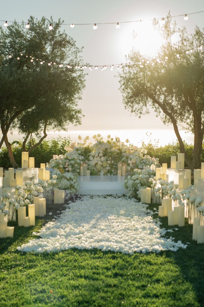 Luxury Malibu engagement with white roses, elevated platform, and garden-style ceremony design