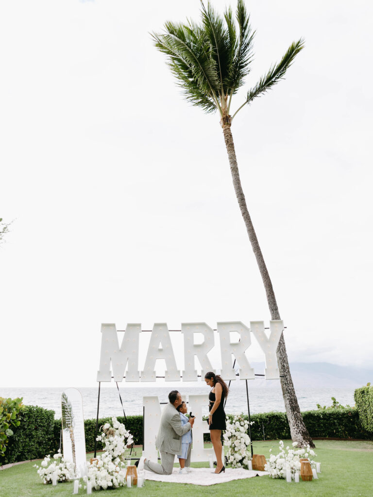 Giant MARRY letters and a palm tree at a Grand Wailea proposal in Maui