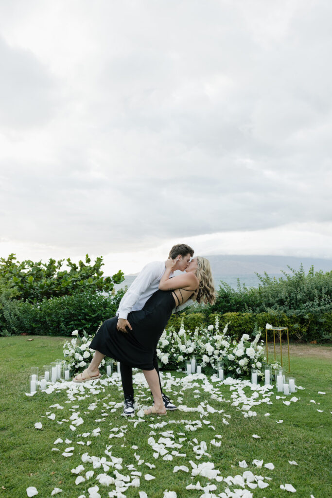 Zach and Amanda share a romantic kiss during their outdoor proposal ceremony.
