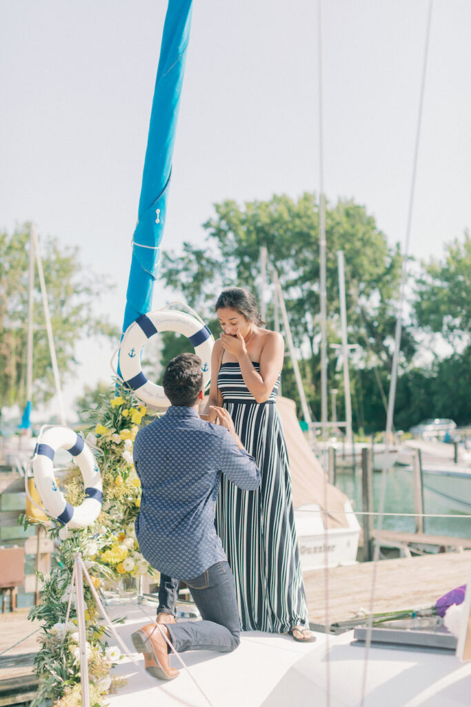 Proposal moment between Asheev and Pooja on a yacht deck.