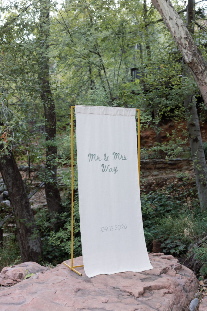 Custom welcome banner set up on the red rocks by the creek