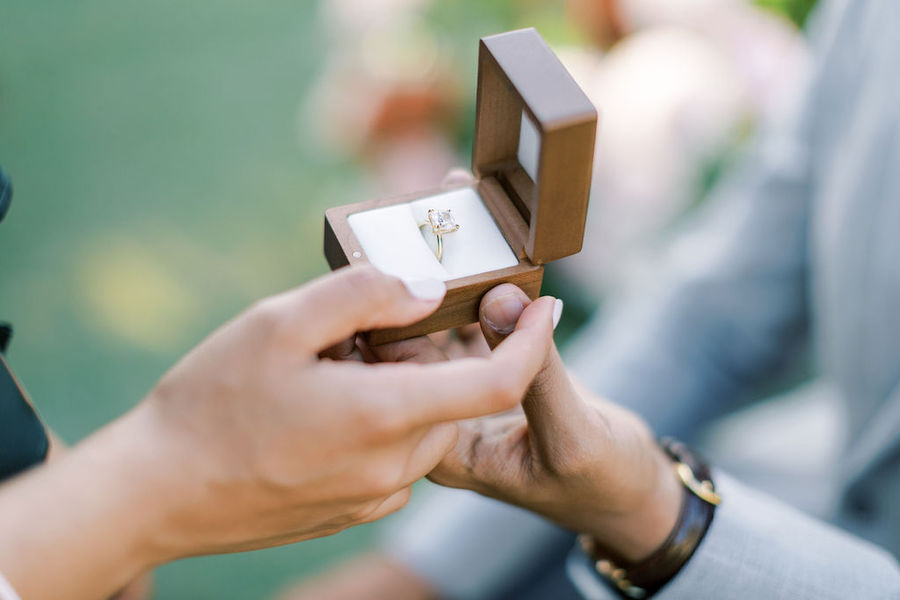Close-up of the open ring box with a diamond engagement ring
