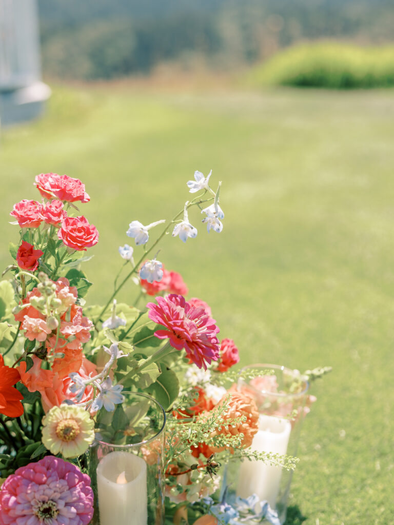 Colorful garden florals and candles on the hillside lawn