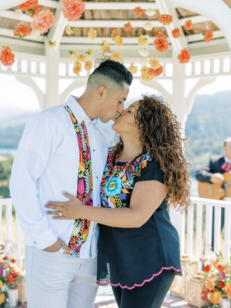 Couple kissing in the gazebo after the proposal