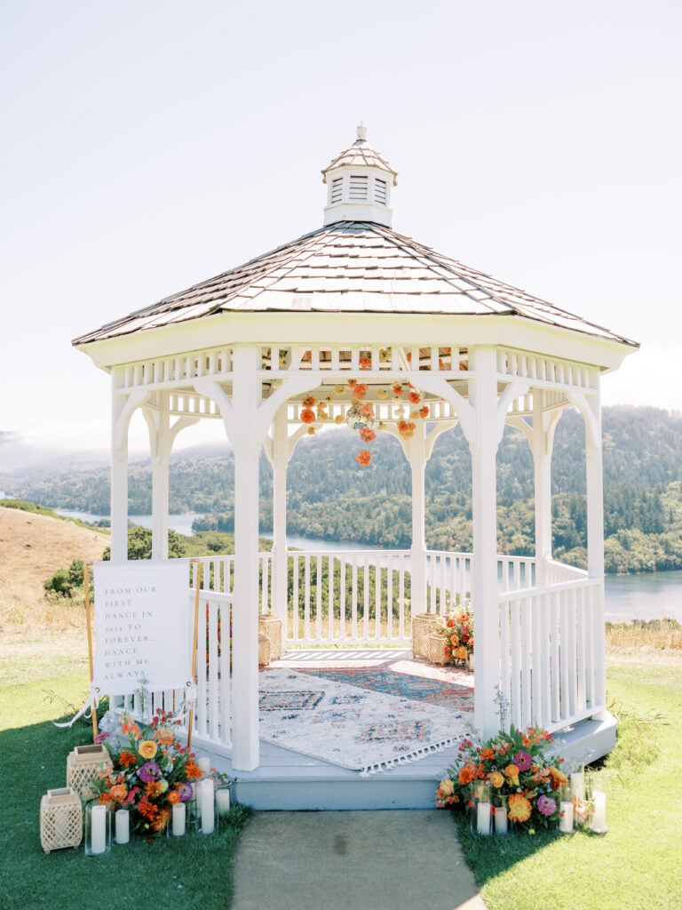 White gazebo with colorful florals overlooking the hills at a Bay Area mariachi proposal