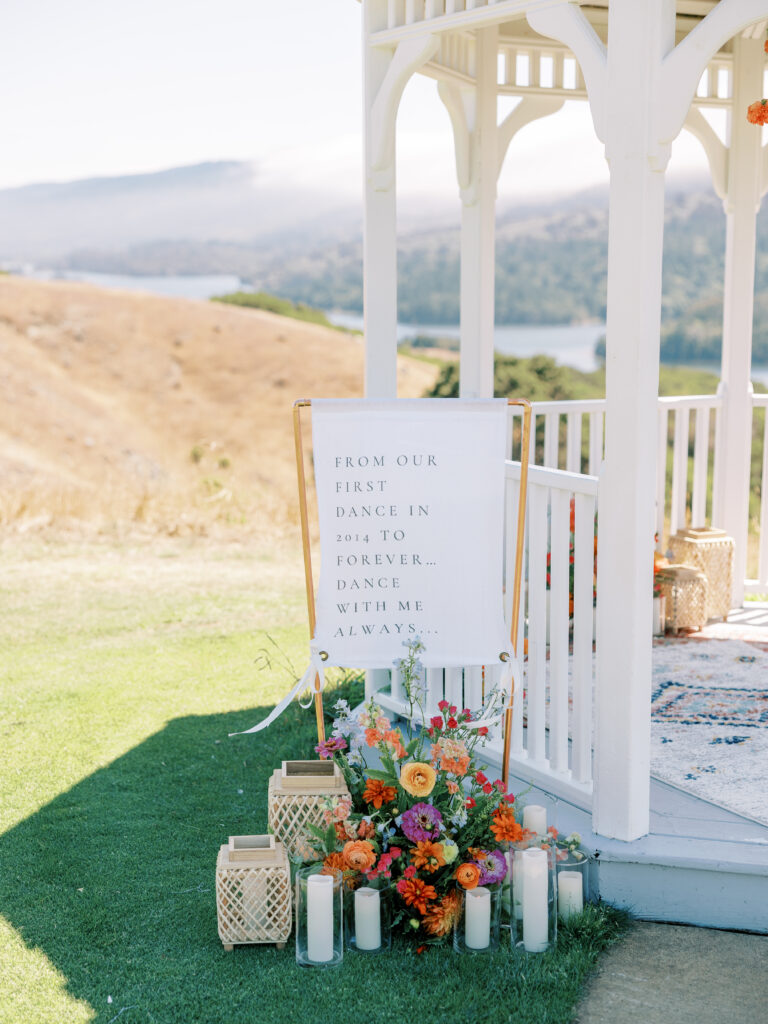 Custom sign and florals at the gazebo entrance