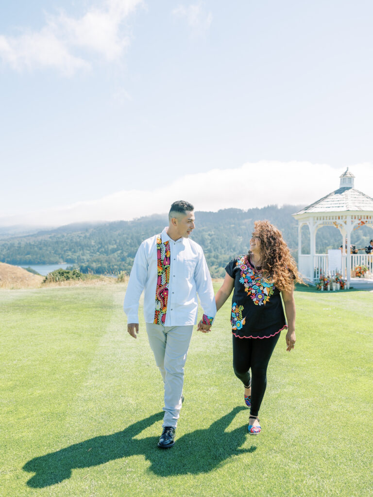 Couple walking hand in hand toward the proposal setup in the Bay Area