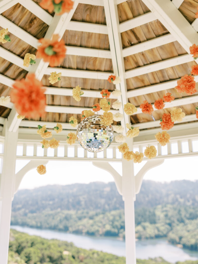 Hanging floral garlands inside the gazebo with lake views