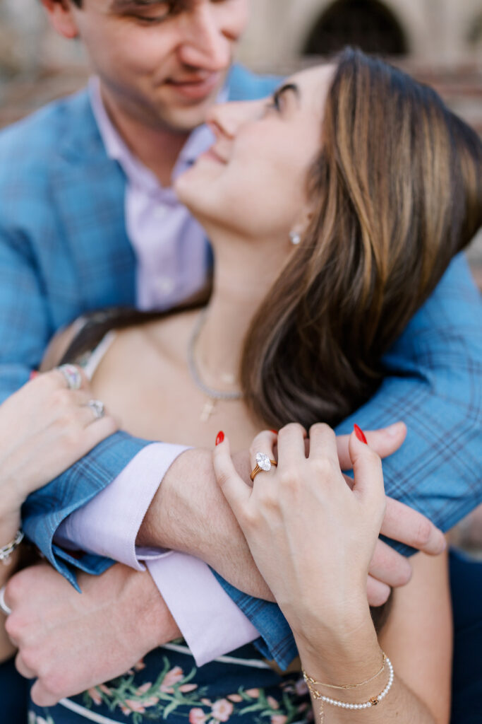 Close-up of the couple embracing with her engagement ring