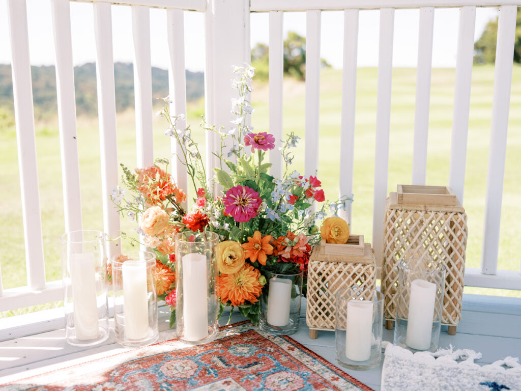 Vibrant florals and woven rugs inside the gazebo