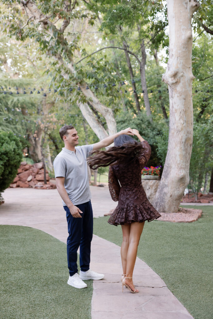 Beck twirls Elle on a tree-lined path