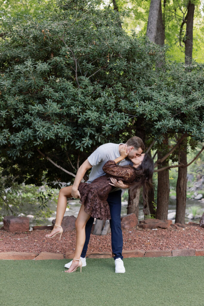 Beck dips Elle for a kiss in the garden