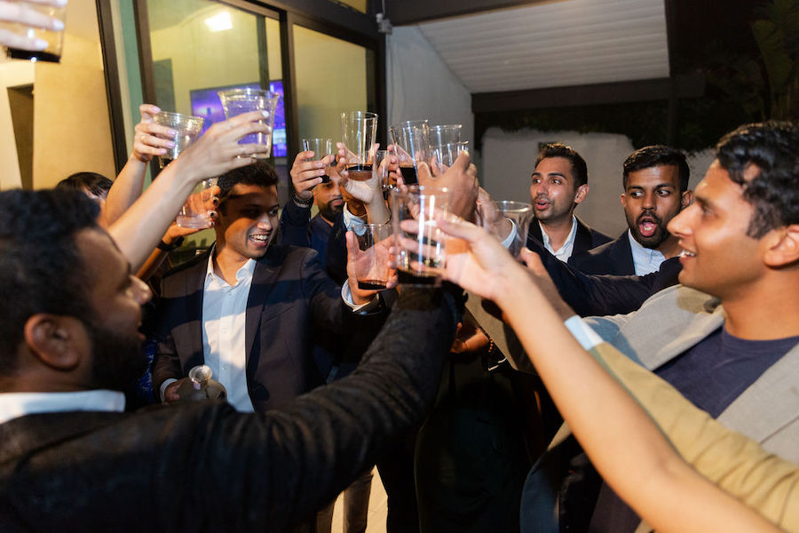 Guests raising champagne glasses in a toast at the engagement party