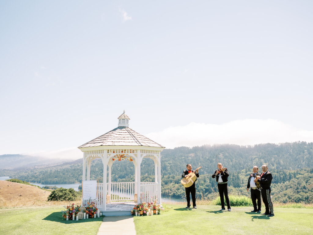 Mariachi musician playing beside the white gazebo