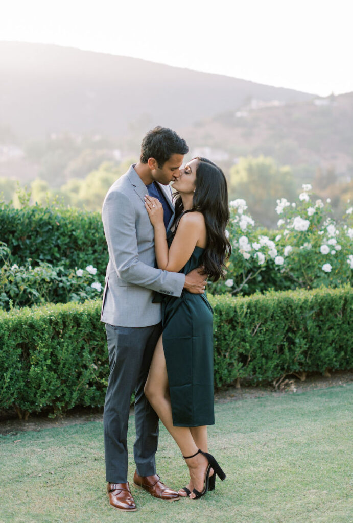 Couple kissing on the lawn after their San Diego proposal