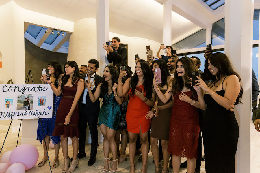 Friends and family cheering for the newly engaged couple