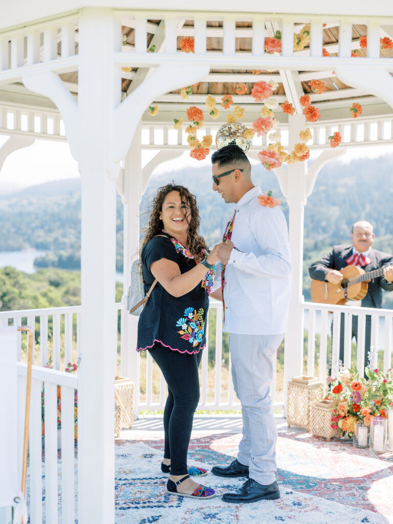 Couple embracing inside the gazebo surrounded by florals