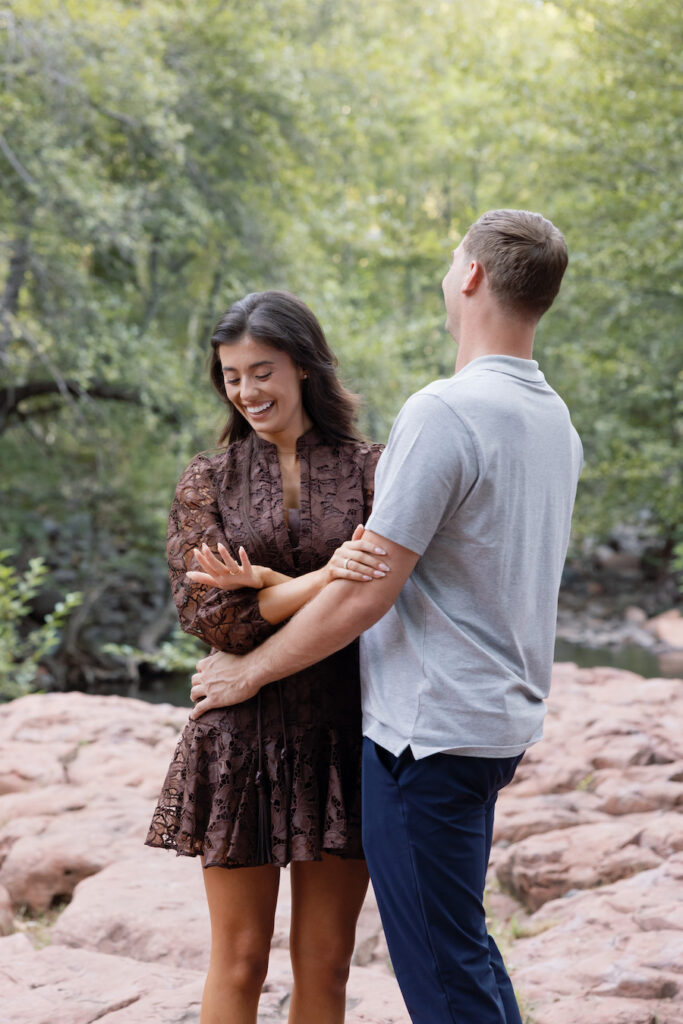 Couple smiling together beside the creek