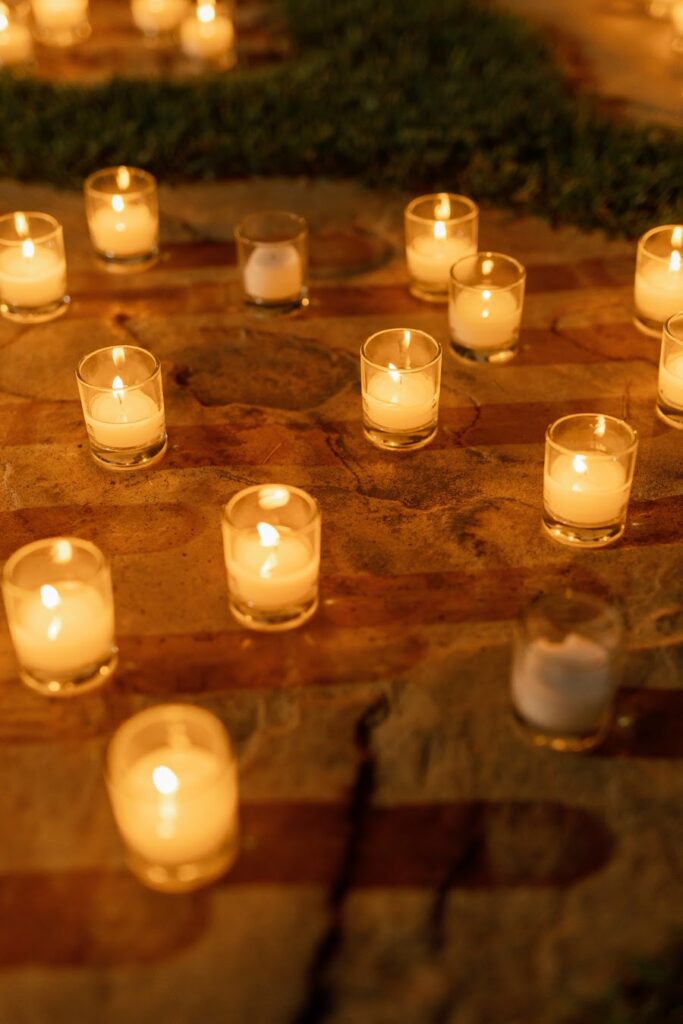 Glowing candles lining the stone path to the gazebo proposal