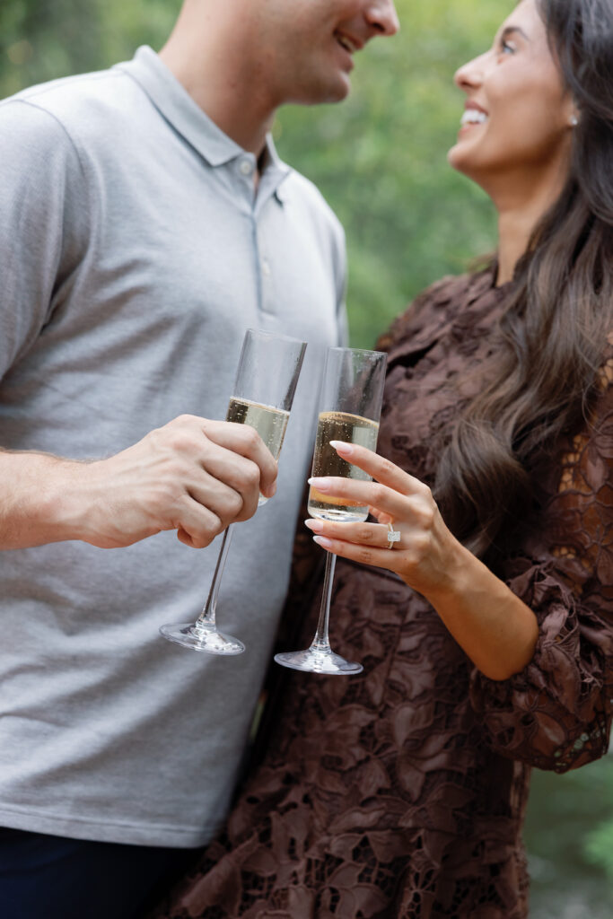 Champagne toast showing off her new engagement ring