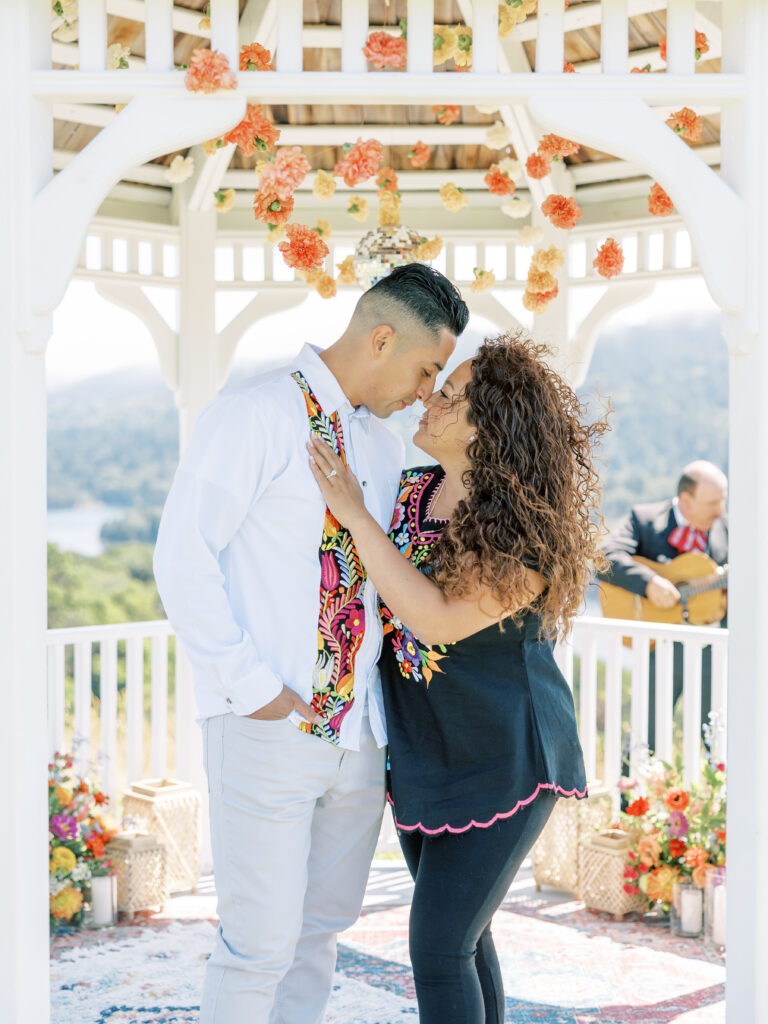 Newly engaged couple smiling together inside the gazebo