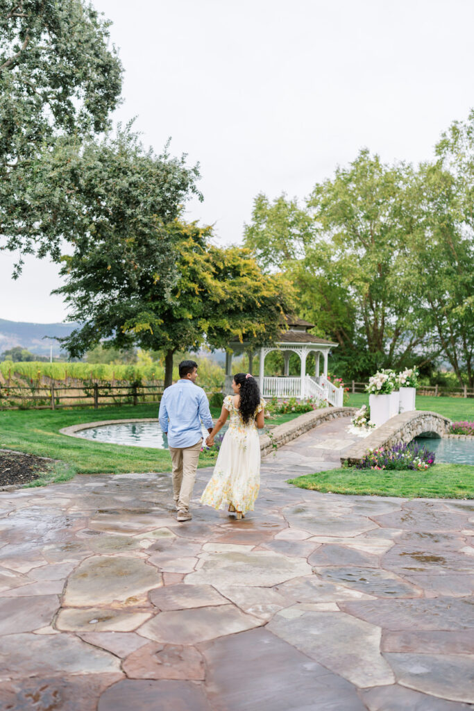 Couple walking along a stone path through the Napa garden estate