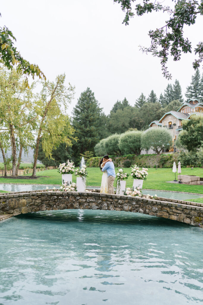 Man proposing on the stone bridge over the pond