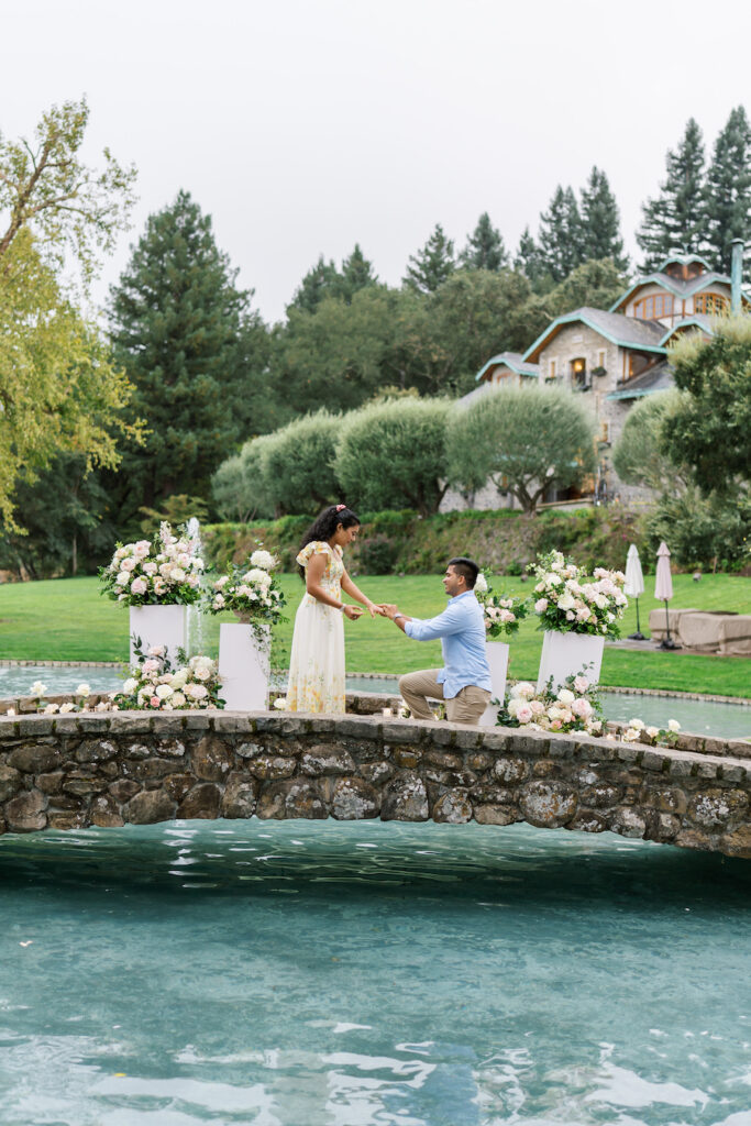 Couple standing on the floral stone bridge in Napa