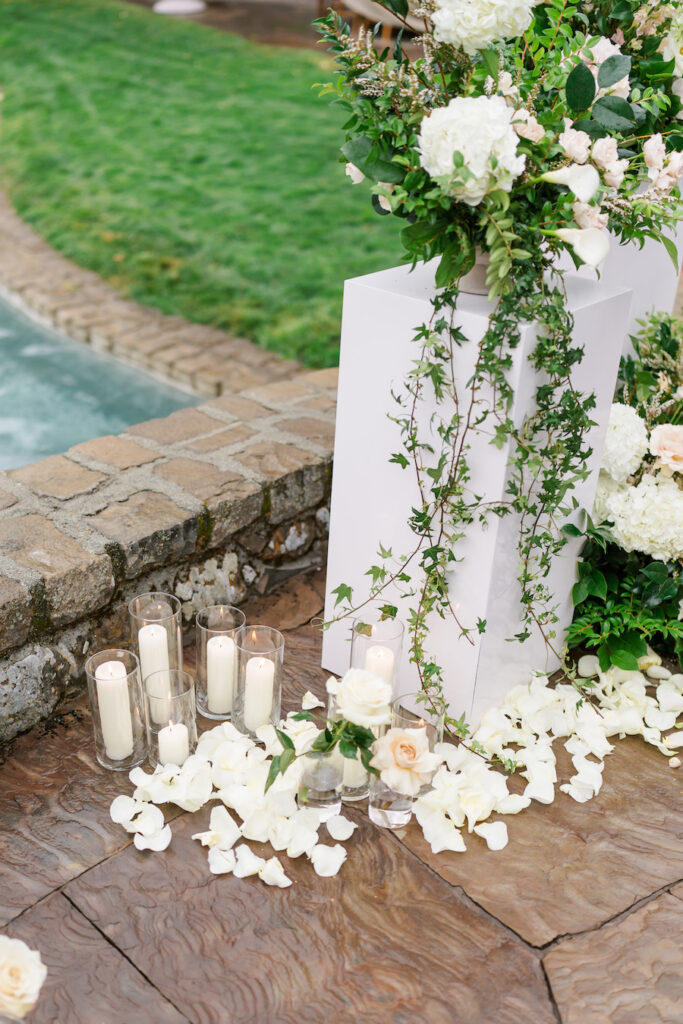 Candles and white florals along the garden steps