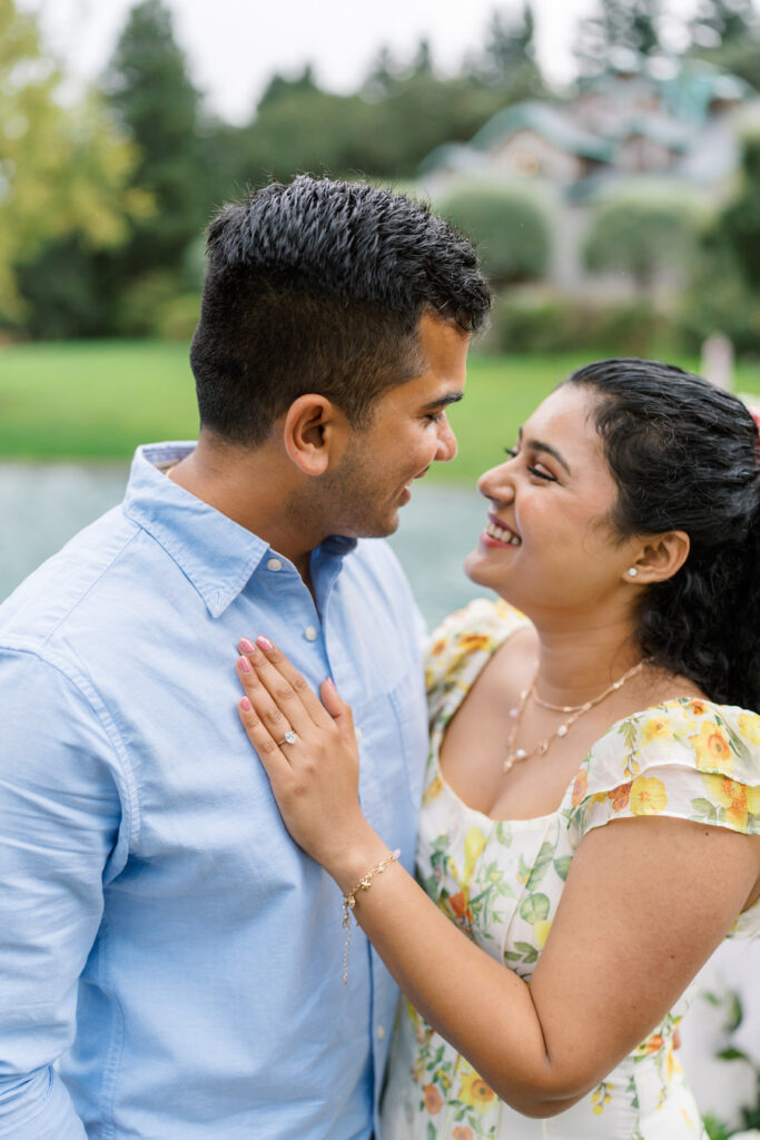 Newly engaged couple smiling face to face