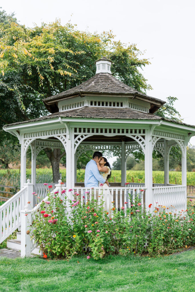 Couple embracing at a garden gazebo during an elegant proposal in Napa, California