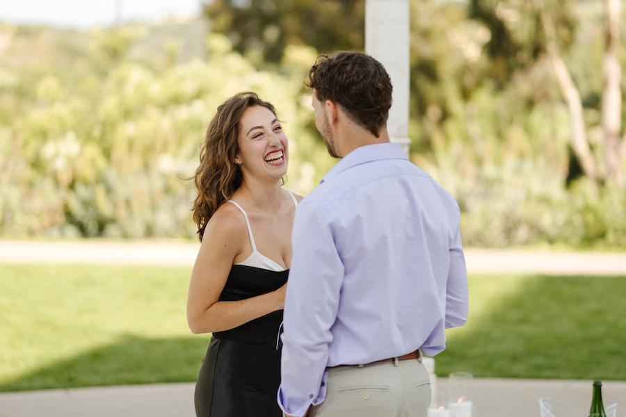 Couple laughing together after their San Diego proposal