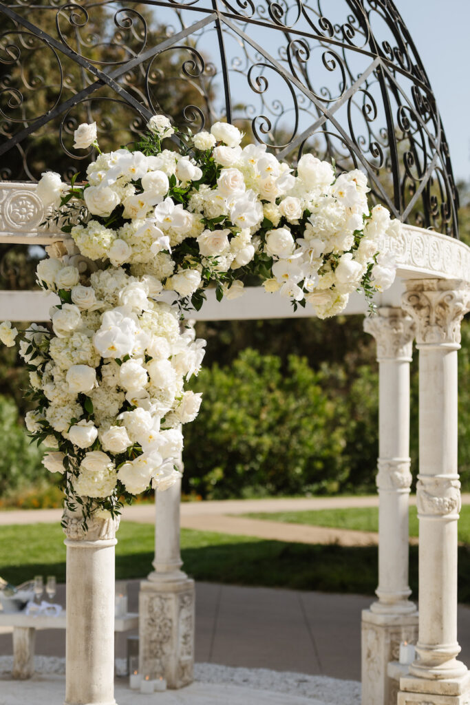 Cascading white roses on an ornate European-inspired gazebo at a San Diego proposal