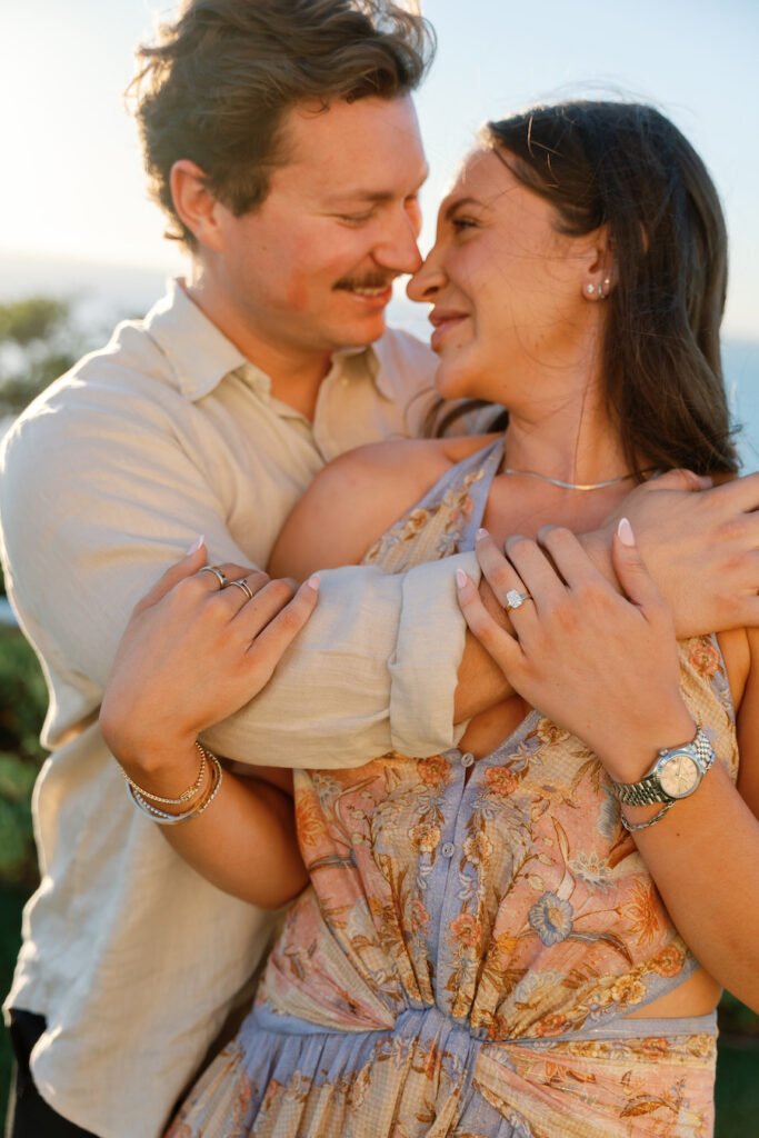 Cody and Nicole smiling face to face with her engagement ring on display