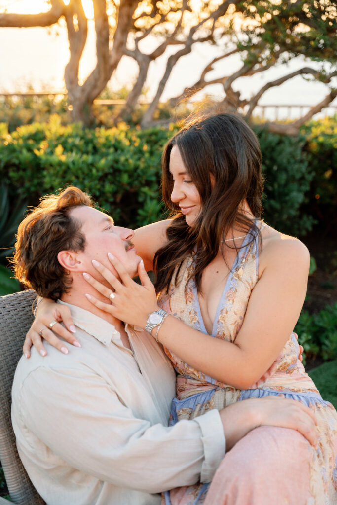 Nicole holding Cody's face as they share a sweet moment on the lawn