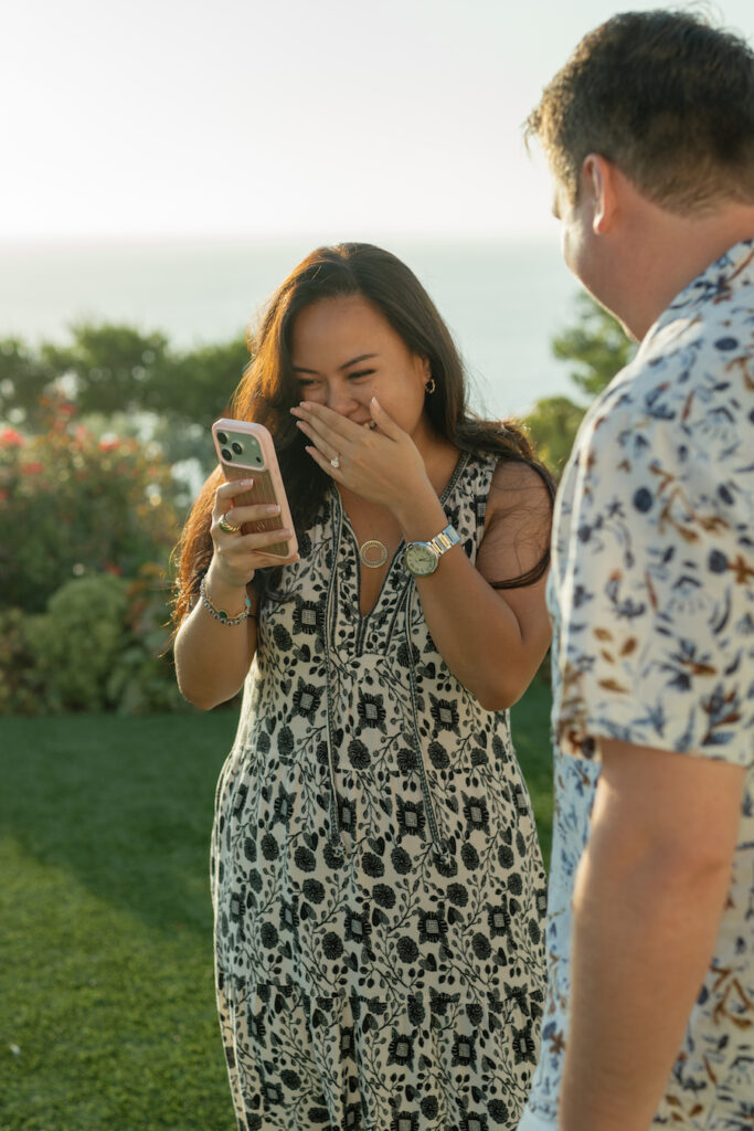 The bride-to-be laughing with joy right after saying yes